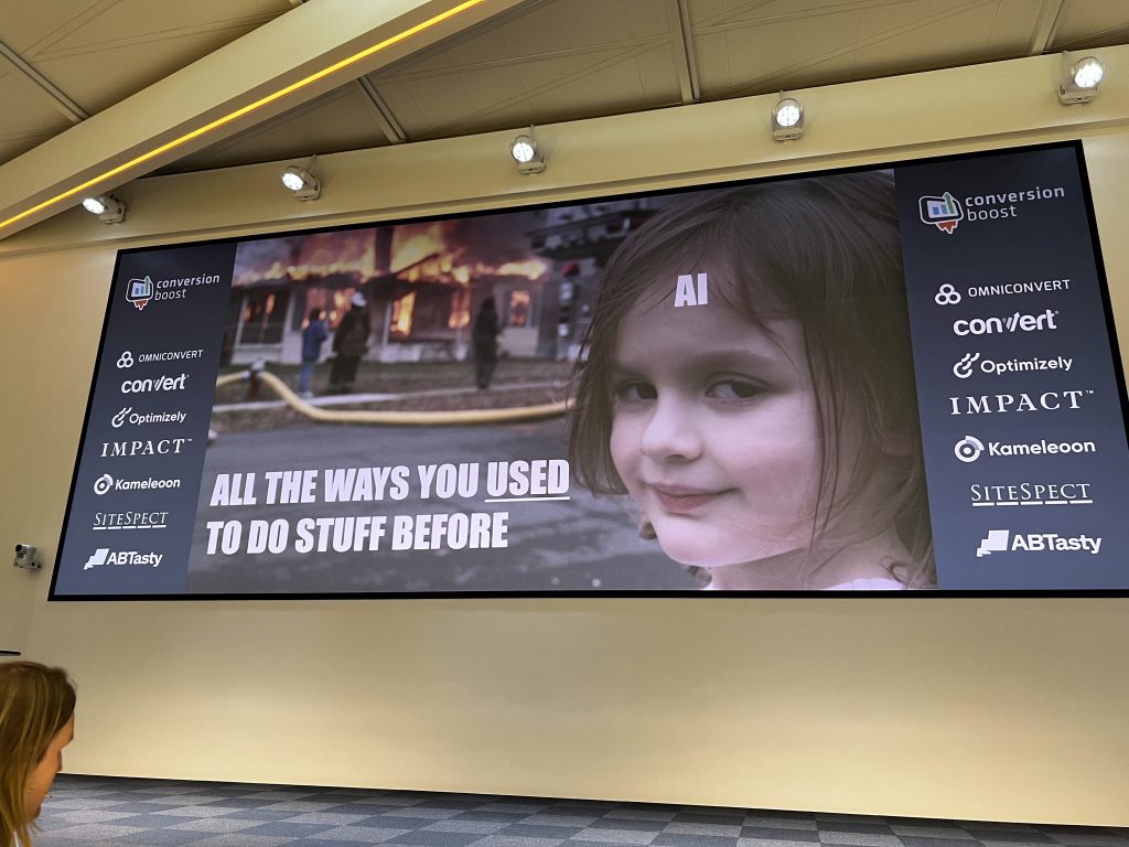 A slide from Craig Sullivan’s remote talk at Cboost shows a funny meme about AI and efficiency, as he presents virtually to the conference audience.