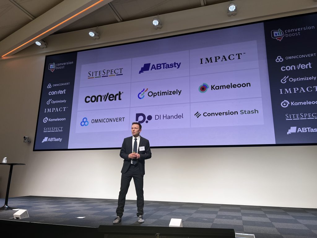 Ole Gregerson stands on stage at Cboost, delivering the closing remarks as the event comes to a close.