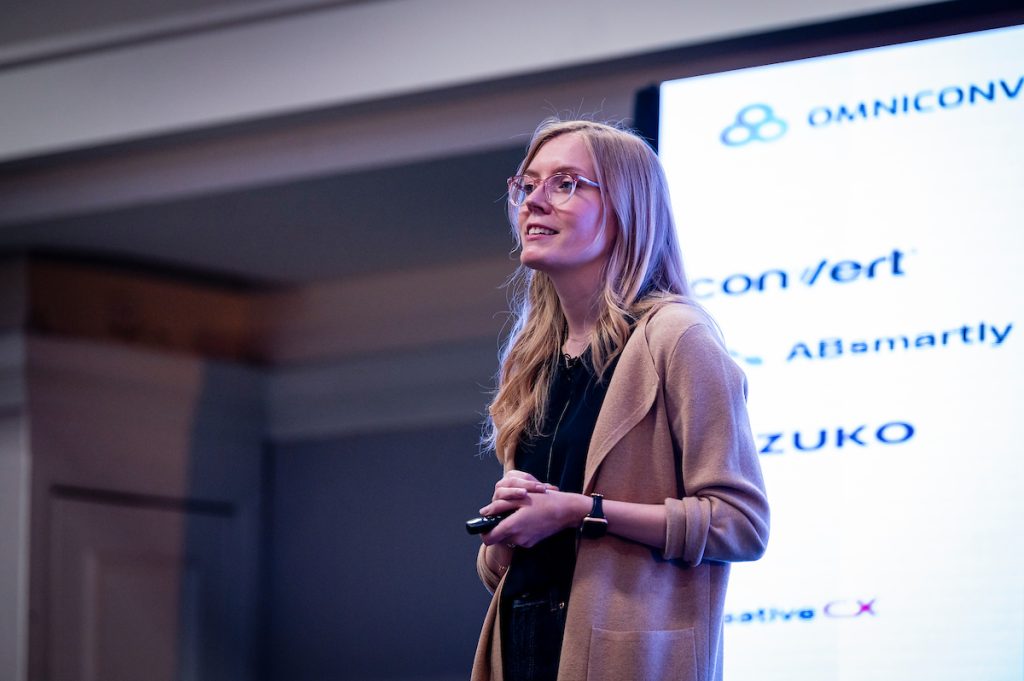 Katie Dove presenting on stage at Experimentation Elite