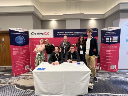 The creative cx team at the creative cx stand at experimentation elite